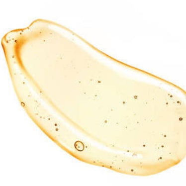 Yellow gel or cream swatch on a white background